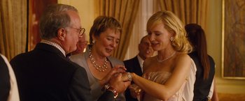 Movie still from “Blue Jasmine” (2013), directed by Woody Allen – A woman is showing her watch to a man and another woman; Close Up shot, Over the shoulder angle