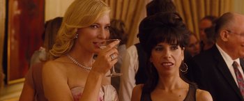 Movie still from “Blue Jasmine” (2013), directed by Woody Allen – Two women are drinking champagne at an event; Close Up shot, Over the shoulder angle