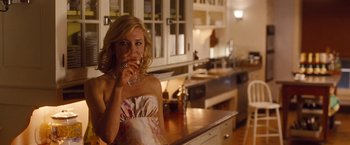 Movie still from “Blue Jasmine” (2013), directed by Woody Allen – A woman drinking a glass of wine in a kitchen; Medium shot, Low angle