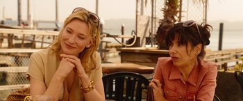 Movie still from “Blue Jasmine” (2013), directed by Woody Allen – Two women sitting at a table in a restaurant; Medium shot, Over the shoulder angle
