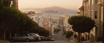 Movie still from “Blue Jasmine” (2013), directed by Woody Allen – Cars parked on the side of a road near the ocean; Extreme Wide shot, High angle