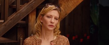 Movie still from “Blue Jasmine” (2013), directed by Woody Allen – A woman with long blonde hair wearing sunglasses; Close Up shot, Over the shoulder angle