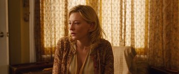 Movie still from “Blue Jasmine” (2013), directed by Woody Allen – A woman sitting on a couch in front of a window; Close Up shot, Over the shoulder angle