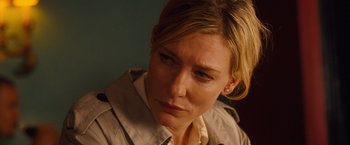 Movie still from “Blue Jasmine” (2013), directed by Woody Allen – A person wearing a trench coat; Close Up shot, Over the shoulder angle