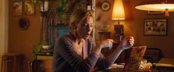 Movie still from “Blue Jasmine” (2013), directed by Woody Allen – A woman sitting in front of a computer desk; Medium shot, Low angle