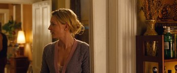 Movie still from “Blue Jasmine” (2013), directed by Woody Allen – A woman standing in front of a door looking in the mirror; Medium shot, Over the shoulder angle