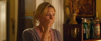 Movie still from “Blue Jasmine” (2013), directed by Woody Allen – A woman is holding her hand up to her face; Close Up shot, Over the shoulder angle