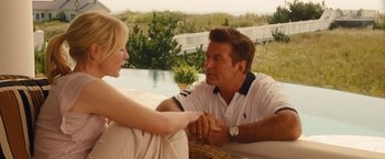 Movie still from “Blue Jasmine” (2013), directed by Woody Allen – A man and a woman holding hands near a swimming pool; Medium shot, Over the shoulder angle