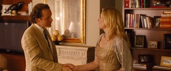 Movie still from “Blue Jasmine” (2013), directed by Woody Allen – A man and a woman shaking hands in a living room; Medium shot, Over the shoulder angle