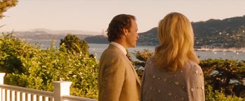 Movie still from “Blue Jasmine” (2013), directed by Woody Allen – A man and a woman standing next to each other near a body of water; Medium shot, Over the shoulder angle