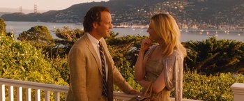 Movie still from “Blue Jasmine” (2013), directed by Woody Allen – A man and a woman standing next to each other; Medium shot, Over the shoulder angle