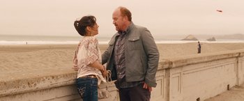 Movie still from “Blue Jasmine” (2013), directed by Woody Allen – A man and a woman standing next to each other on the beach; Medium shot, Over the shoulder angle