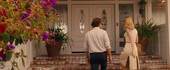 Movie still from “Blue Jasmine” (2013), directed by Woody Allen – A man standing in front of a door way; Wide shot, Over the shoulder angle