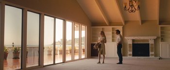 Movie still from “Blue Jasmine” (2013), directed by Woody Allen – Two people standing in front of a large open window; Wide shot, Low angle