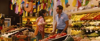 Movie still from “Blue Jasmine” (2013), directed by Woody Allen – A man and a woman talking in a market; Medium shot, Over the shoulder angle