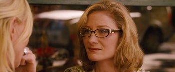 Movie still from “Blue Jasmine” (2013), directed by Woody Allen – A person wearing glasses and looking to her left; Close Up shot, Over the shoulder angle