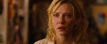Movie still from “Blue Jasmine” (2013), directed by Woody Allen – A woman with blonde curly hair is crying; Close Up shot, Over the shoulder angle