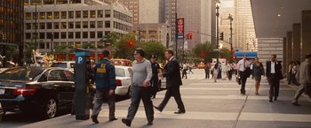 Movie still from “Blue Jasmine” (2013), directed by Woody Allen – A group of people crossing the street at a busy intersection; Wide shot, Over the shoulder angle