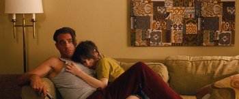 Movie still from “Blue Jasmine” (2013), directed by Woody Allen – A man and a woman laying on a couch together; Medium shot, Over the shoulder angle