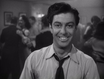 Movie still from “Blues in the Night” (1941), directed by Anatole Litvak – A black and white photo of a man in a tie; Close Up shot, Low angle