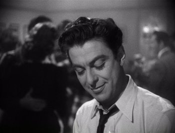 Movie still from “Blues in the Night” (1941), directed by Anatole Litvak – A black and white photo of a man in a tie; Close Up shot, Low angle