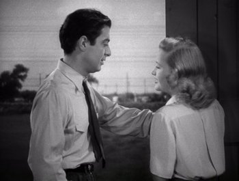 Movie still from “Blues in the Night” (1941), directed by Anatole Litvak – A man and a woman are looking at one another; Medium shot, Low angle
