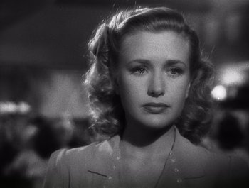 Movie still from “Blues in the Night” (1941), directed by Anatole Litvak – A black - and - white photo of a woman in a dress; Close Up shot, Low angle