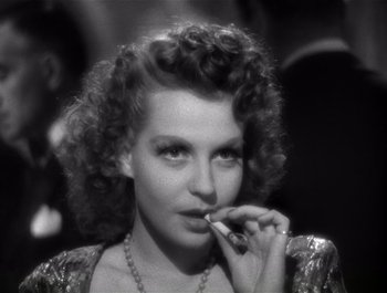 Movie still from “Blues in the Night” (1941), directed by Anatole Litvak – A black - and - white photo of a woman smoking a cigarette; Close Up shot, High angle