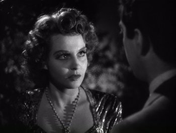 Movie still from “Blues in the Night” (1941), directed by Anatole Litvak – An old photo of a man and a woman talking; Close Up shot, Over the shoulder angle