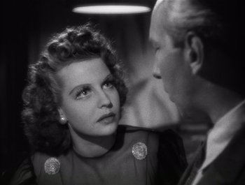 Movie still from “Blues in the Night” (1941), directed by Anatole Litvak – An old black and white photo of a man and a woman; Close Up shot, High angle