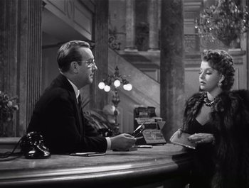 Movie still from “Blues in the Night” (1941), directed by Anatole Litvak – A man and a woman sitting at a table; Medium shot, Over the shoulder angle