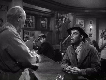 Movie still from “Blues in the Night” (1941), directed by Anatole Litvak – Two men are sitting at a bar talking to each other; Medium shot, Over the shoulder angle