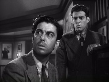 Movie still from “Blues in the Night” (1941), directed by Anatole Litvak – Two men in suits and ties looking at the camera; Close Up shot, Low angle