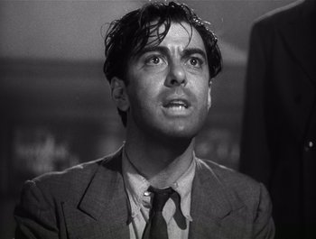 Movie still from “Blues in the Night” (1941), directed by Anatole Litvak – A man in a suit and tie looking up; Close Up shot, Low angle