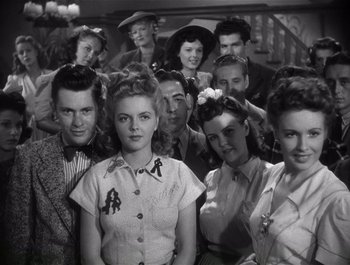 Movie still from “Blues in the Night” (1941), directed by Anatole Litvak – A group of people that are posing for a picture; Medium shot, Low angle