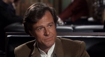 Movie still from “Bob & Carol & Ted & Alice” (1969), directed by Paul Mazursky – A person wearing a suit and tie; Close Up shot, Over the shoulder angle