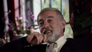 Movie still from “Bob Roberts” (1992), directed by Tim Robbins – An older man with grey hair and a gray beard; Close Up shot, Low angle