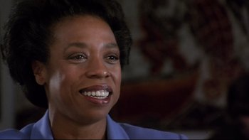 Movie still from “Bob Roberts” (1992), directed by Tim Robbins – A person with a smile on their face; Close Up shot, Low angle