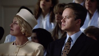 Movie still from “Bob Roberts” (1992), directed by Tim Robbins – A man and a woman in a crowd of people; Close Up shot, Low angle
