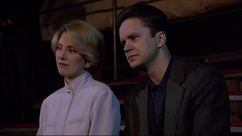 Movie still from “Bob Roberts” (1992), directed by Tim Robbins – A man and a woman standing next to each other; Close Up shot, Low angle
