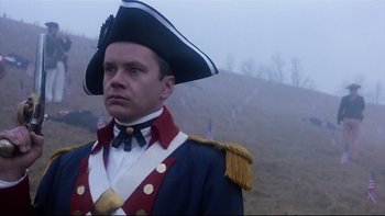 Movie still from “Bob Roberts” (1992), directed by Tim Robbins – A man in a military uniform with a hat on; Close Up shot, Low angle
