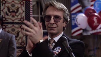 Movie still from “Bob Roberts” (1992), directed by Tim Robbins – A man in a suit and tie clapping; Close Up shot, Low angle