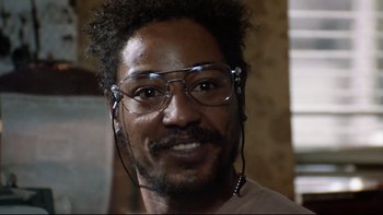 Movie still from “Bob Roberts” (1992), directed by Tim Robbins – A person wearing glasses; Close Up shot, Low angle