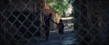 Movie still from “The Amazing Spider-Man 2” (2014), directed by Marc Webb – A man and a boy walking down a street; Wide shot, Over the shoulder angle