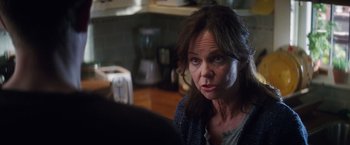 Movie still from “The Amazing Spider-Man 2” (2014), directed by Marc Webb – A person sitting in a room; Close Up shot, Over the shoulder angle