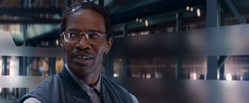 Movie still from “The Amazing Spider-Man 2” (2014), directed by Marc Webb – A person wearing glasses and a vest; Close Up shot, Over the shoulder angle