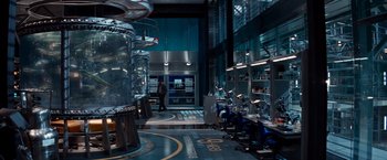 Movie still from “The Amazing Spider-Man 2” (2014), directed by Marc Webb – A man is standing in a room with a lot of equipment; Wide shot, High angle