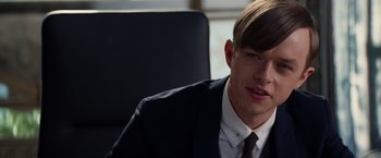 Movie still from “The Amazing Spider-Man 2” (2014), directed by Marc Webb – A man in a suit sitting in an office chair; Close Up shot, Over the shoulder angle