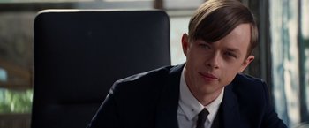 Movie still from “The Amazing Spider-Man 2” (2014), directed by Marc Webb – A man in a suit sitting in an office chair; Close Up shot, Over the shoulder angle