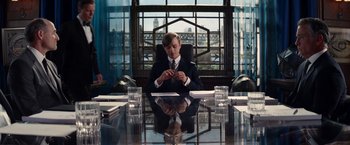 Movie still from “The Amazing Spider-Man 2” (2014), directed by Marc Webb – A man sitting at a table in front of a window; Medium shot, Over the shoulder angle